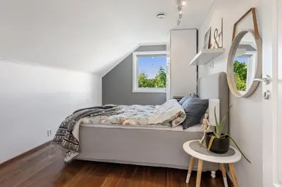 a bedroom with a bed and a mirror at Beachfront Villa with Jacuzzi, Cinema & Canoe in Bergen