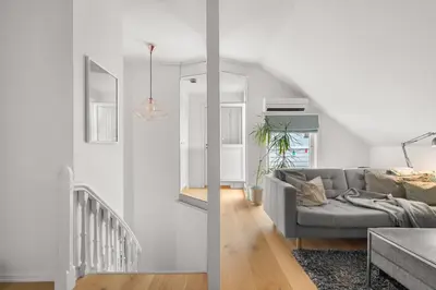 a living room with a couch and a table at Historic Townhouse I With Rooftop & Free Parking in Bergen
