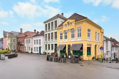 a row of colorful buildings on a street at Historic Townhouse I With Rooftop & Free Parking in Bergen