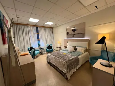a bedroom with a bed and a living room at Dokka Motell in Dokka