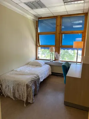 a bedroom with a bed and a large window at Dokka Motell in Dokka