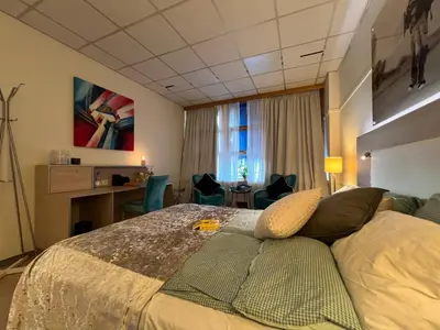 a hotel room with a bed and a desk at Dokka Motell in Dokka