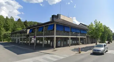 a building with a car parked in front of it at Dokka Motell in Dokka