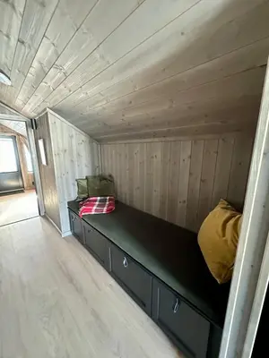 a bed in the inside of a tiny house at Ski in and ski out in the middle of the slopes in Favang