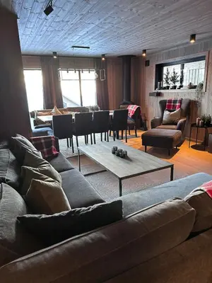 a living room with a couch and a table at Ski in and ski out in the middle of the slopes in Favang