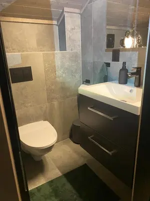 a bathroom with a toilet and a sink at Ski in and ski out in the middle of the slopes in Favang