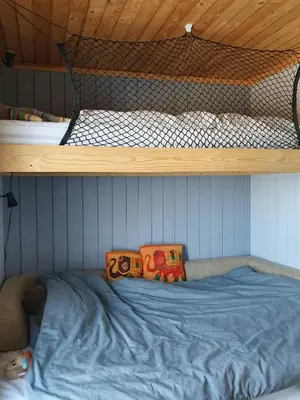 a boy laying on the bottom bunk of a bunk bed at Nature-Close Cabin In Tranquil Mountain Area in Ulnes