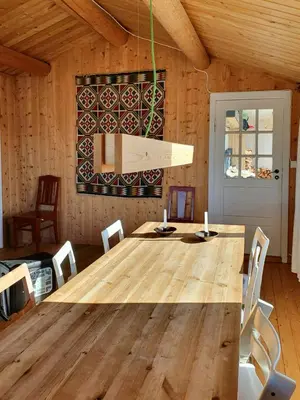 a dining room with a wooden table and chairs at Nature-Close Cabin In Tranquil Mountain Area in Ulnes