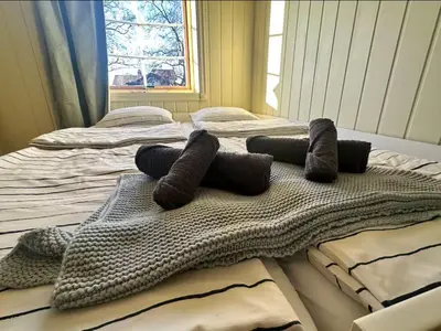 a large bed with a bunch of pillows on it at Cozy rooms with private bathroom close to Hønefoss in Knestang