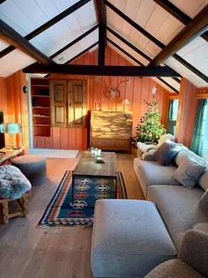 a living room with a couch and a table at Authentic Norwegian chalet for 8 with fireplaces & modern comfort near Geilo ski slopes in Geilo