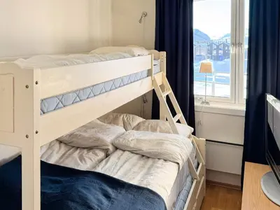 two bunk beds in a room with a window at 4 star holiday home in HOVDEN in Hovden