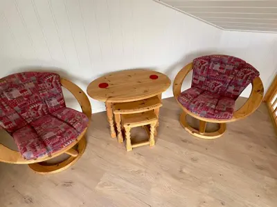 a room with two chairs and a wooden table at 4 star holiday home in Tjeldstø in Tjeldstø