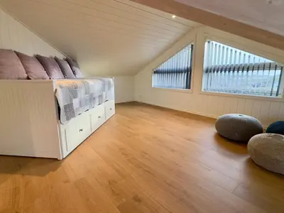 a large room with a bed and two windows at 4 star holiday home in Tjeldstø in Tjeldstø