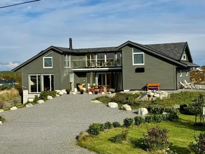 a house with a gravel driveway in front of it at 4 star holiday home in Tjeldstø in Tjeldstø
