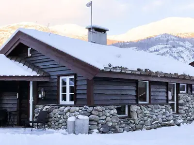a log cabin with snow on top of it at 8 person holiday home in Hemsedal in Hemsedal