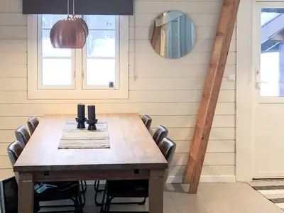 a dining room with a wooden table and chairs at 8 person holiday home in Hemsedal in Hemsedal