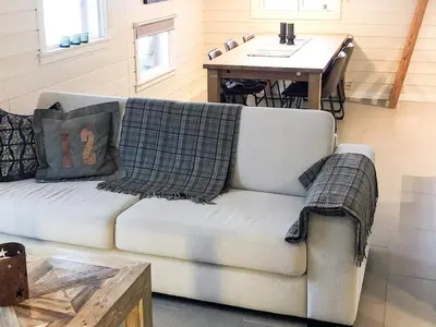 a living room with a couch and a table at 8 person holiday home in Hemsedal in Hemsedal