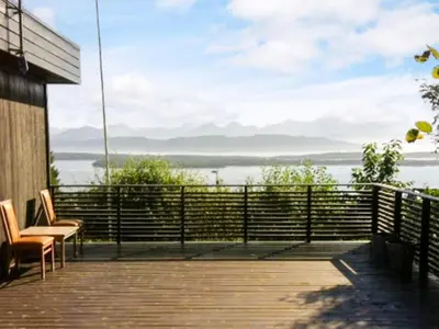 a deck with chairs and a view of the water at 7 person holiday home in Molde in Molde
