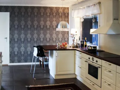 a kitchen with a black and white counter top at 7 person holiday home in Molde in Molde