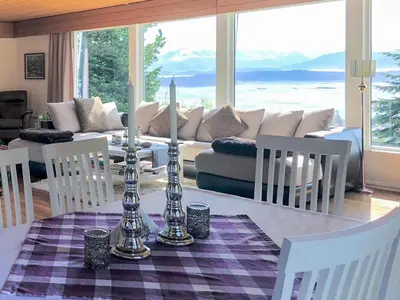 a living room with a table and a couch at 7 person holiday home in Molde in Molde