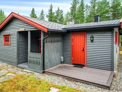 a shed with a red door and a wooden deck at 5 person holiday home in Røros in Røros