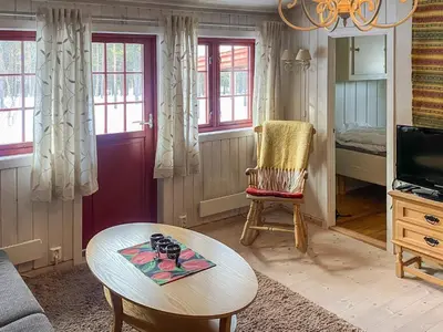 a living room with a table and a chair at 5 person holiday home in Røros in Røros