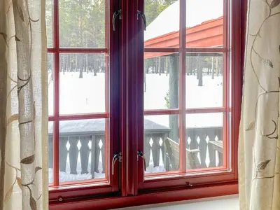a red window with a view of a balcony at 5 person holiday home in Røros in Røros