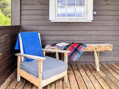 a chair and a bench on a wooden deck at 4 person holiday home in gol in Gol