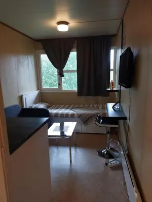 a small living room with a couch and a bed at Cozy room away from home in Åmot