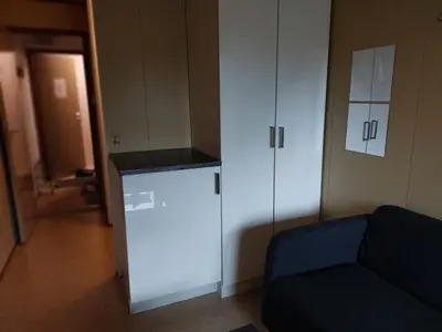 a living room with a couch and a white cabinet at Cozy room away from home in Åmot