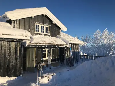 an old wooden house covered in snow at Bjønnhiet in Trysil
