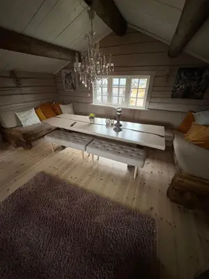 a living room with a couch and a table at Bjønnhiet in Trysil