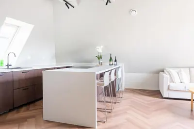 a kitchen with a white island in a room at Large apartment in historical street in Bergen