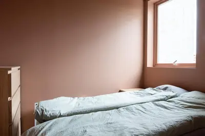 a bed in a room with a window at Large apartment in historical street in Bergen