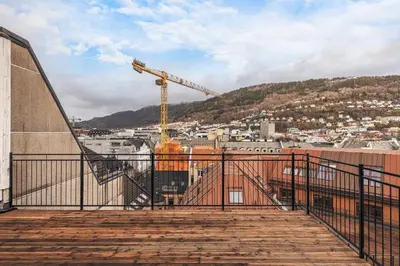 a view of a city with a construction crane at Rosenberg Apartments in Bergen