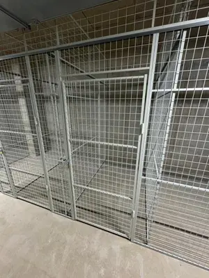 a metal cage with a door in a room at Helt NY leilighet, Ytre Sandviken i Bergen in Bergen