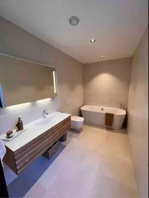 a bathroom with a tub and a sink and a toilet at Luxury apartment with beautiful location in Florvåg