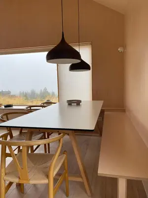 a dining room with a white table and chairs at Birkenstua in Ringsaker