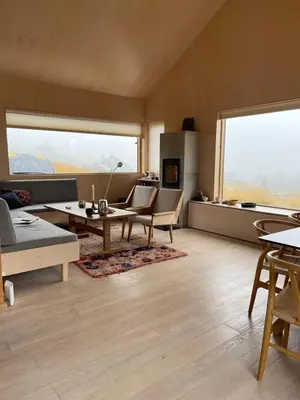 a living room with a couch and a table at Birkenstua in Ringsaker