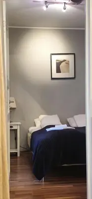 a bedroom with a bed and a picture on the wall at Øvregaten in Bergen