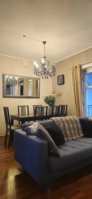 a living room with a couch and a dining table at øvregaten in Bergen