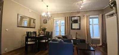 a living room with a blue couch and a table at øvregaten in Bergen