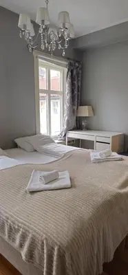 a bedroom with a bed with two towels on it at øvregaten in Bergen