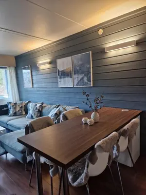 a living room with a table and a couch at Storehorn Apartments Hemsedal in Fausko
