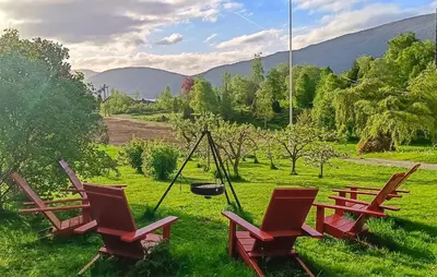 a group of chairs and a swing in a field at Nice Home In Stårheim With Wifi in Stårheim