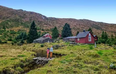 a man and a woman standing on a rock in a river at Nice Home In Stårheim With Wifi in Stårheim