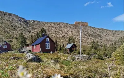 a street sign in front of a house on a hill at Nice Home In Stårheim With Wifi in Stårheim