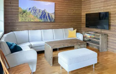 a living room with a couch and a table and a tv at 2 Bedroom Cozy Apartment In Stranda in Stranda