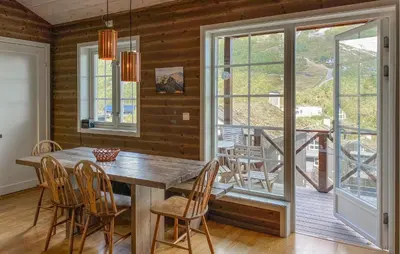 a dining room with a wooden table and chairs at 2 Bedroom Cozy Apartment In Stranda in Stranda