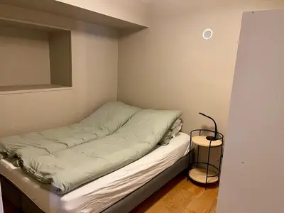 a small room with a bed in the corner at Sjøutsikt in Bergen